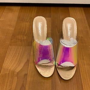 Clear high heeled shoes with aero descent middle.